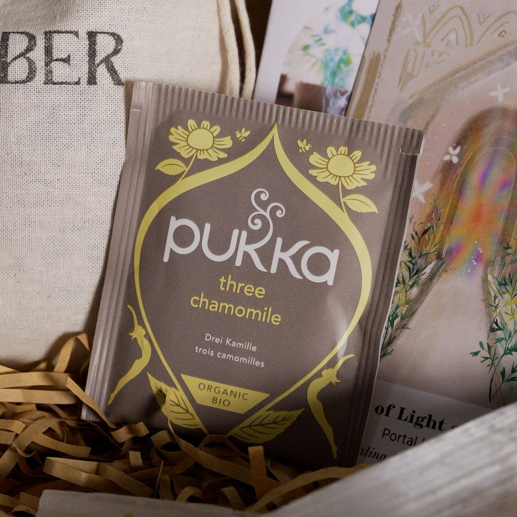 Pukka chamomile tea packet in a box with other items