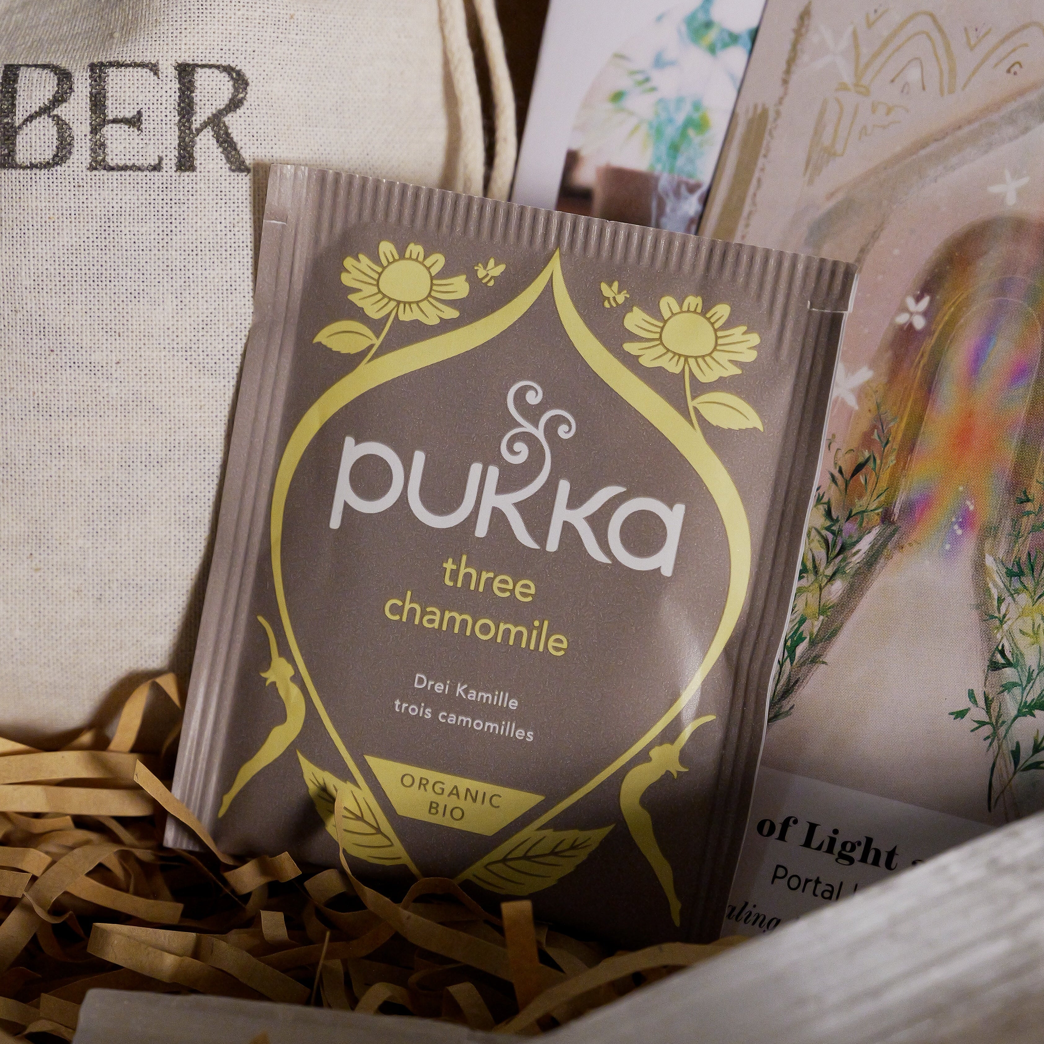 Pukka chamomile tea packet in a box with other items